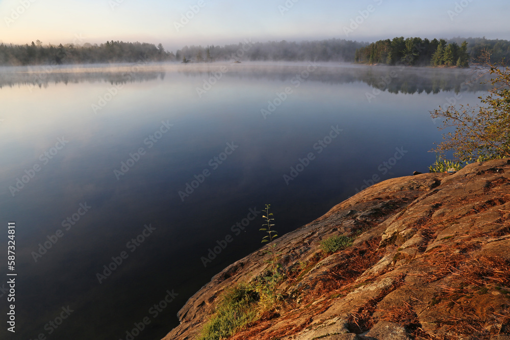 A misty morning on Sunbeam Lake in Algonquin Provincial Park, Ontario, Canada..