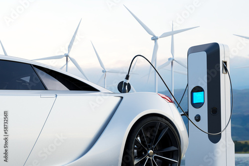 Electric car connected to charger with wind turbines in the background