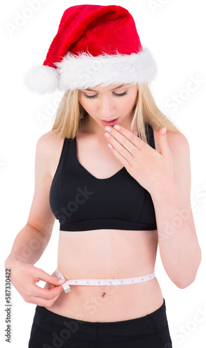 Fit festive young blonde looking at measuring tape