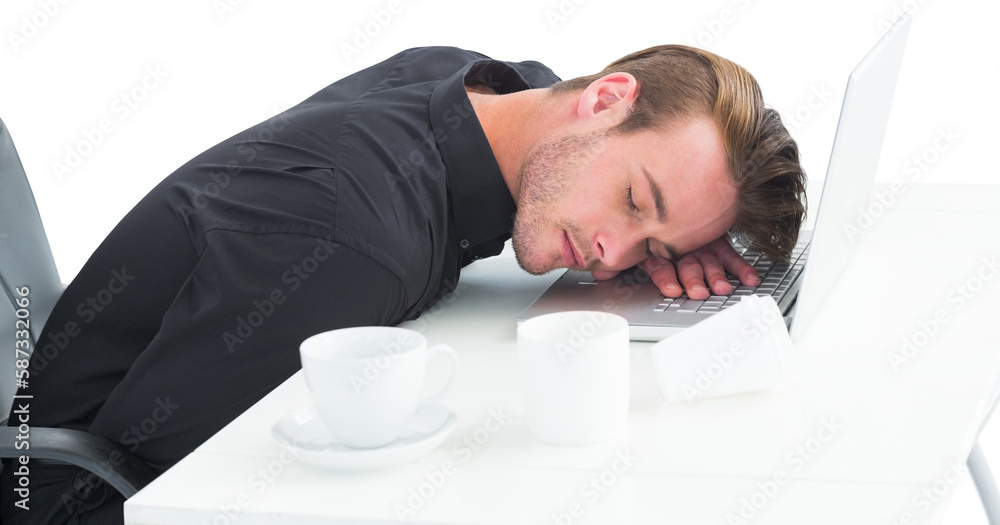 Obraz premium Tired businessman sleeping on laptop