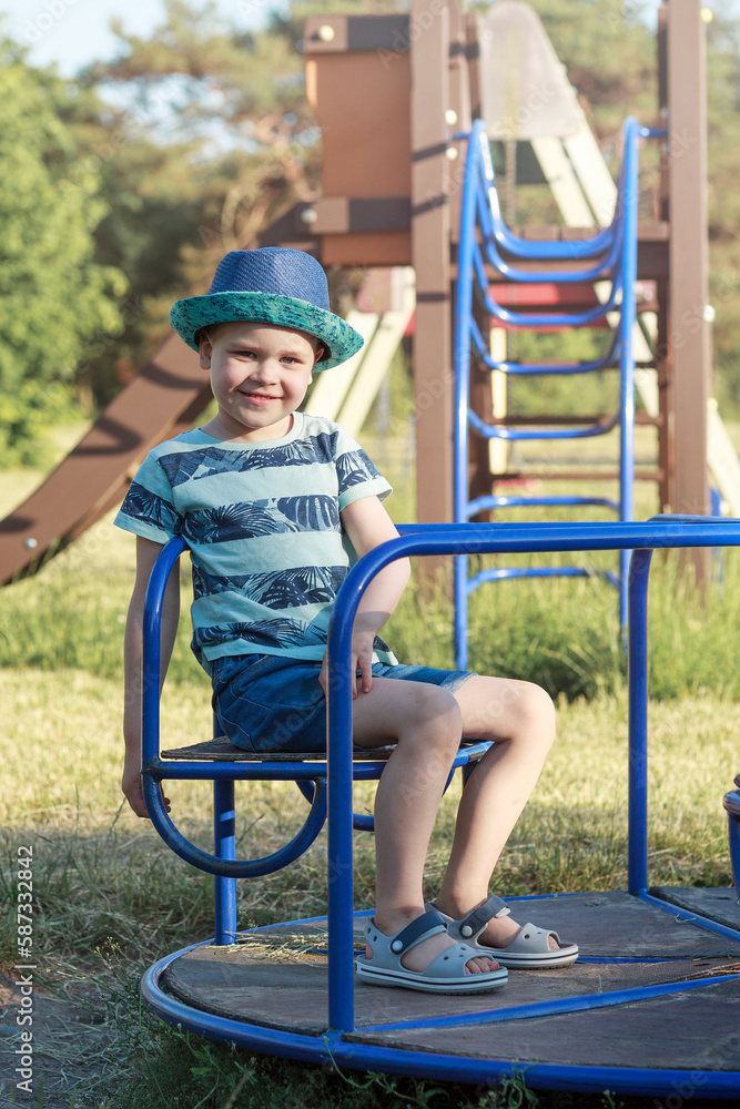 Portrait of a smiling boy in blue clothes on a blue carousel. Portrait of a smiling boy in blue clothes on a blue carousel.