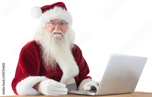 Santa pays with credit card on a laptop