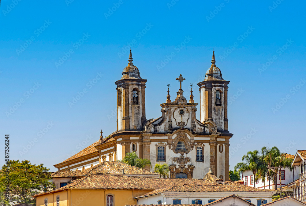 Historic church and its towers rising from among the colonial-style houses in the city of Ouro Preto in the state of Minas Gerais