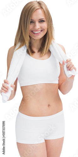 Portrait of happy woman in sportswear holding towel around neck © vectorfusionart