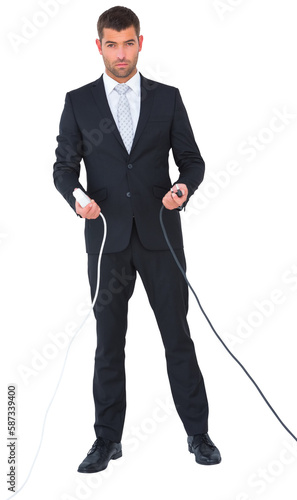 Serious businessman holding cables to connect