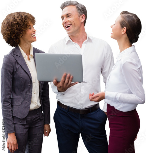 Business people laughing while discussing over laptop