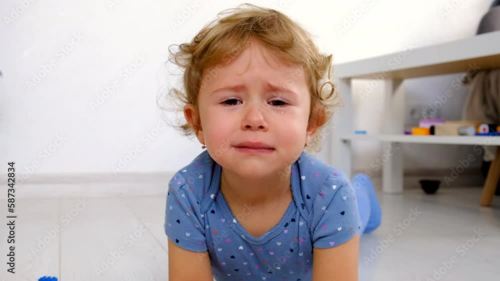The child is crying in the room. Selective focus. The child is crying in the room. Selective focus.