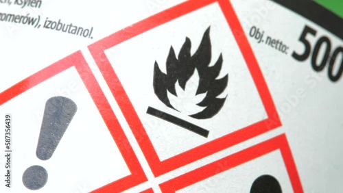 Dangerous flammable corrosive substance bottle packaging, red warning signs, customer safety, security, damaging chemical substance symbols, object detail, extreme closeup, nobody. Chemicals bottle