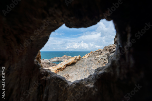 View of the rocky cliff of Cap de Creus and the Mediterranean Sea through the opening of the cave on a sunny day - June 2018 - Catalonia, Spain photo
