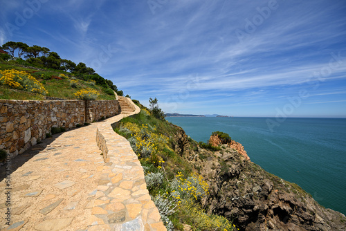 Coastal path along the cliff with view to sea, mountains and the Medes Islands in the background  - June 2018 - Sa Riera, Catalonia, Spain