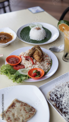 Food serving rice with fried chicken and vegetable on the table in a restaurant.