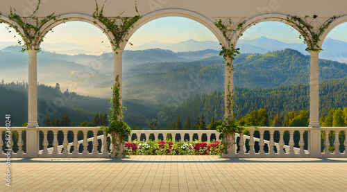 Panoramic view from the terrace over the mountain range and dense forest. Terrace with columns and balustrade on a sunny morning. photo