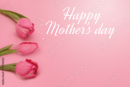 Happy Mother's day lettering and gentle tulips on pink background. Greeting card concept. Copy Space