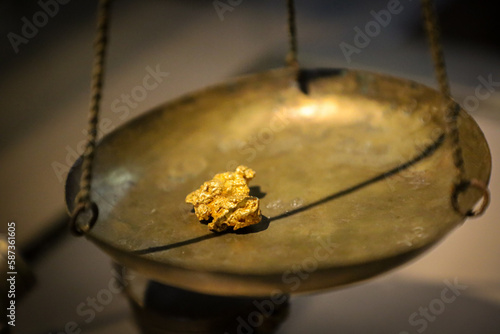 gold nugget on a scale to measure your weight