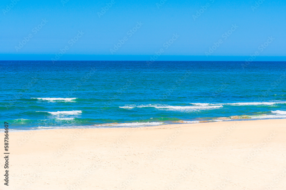 A beach with a blue sky 
