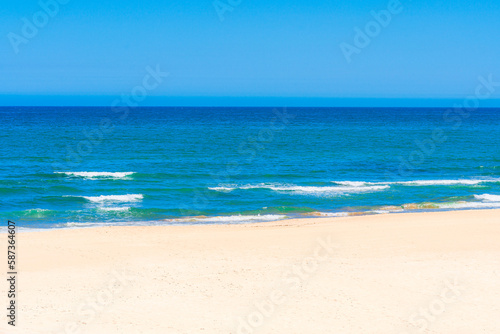 A beach with a blue sky 