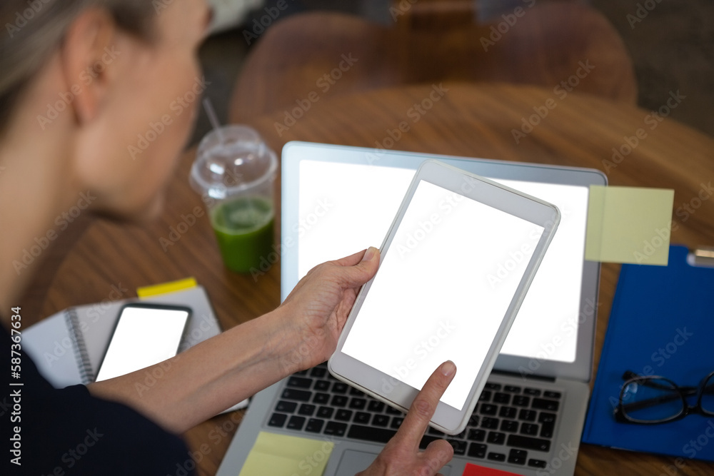 Cropped image of businesswoman using tablet while working