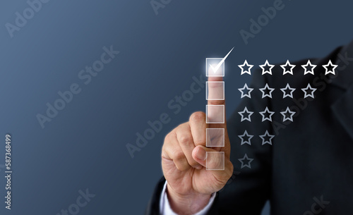 Close up Man hand give five star symbol to increase rating of product and service concept, Customer service and business satisfaction survey,selective focus.