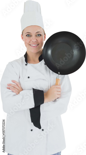 Female chef with arms crossed holds frying pan