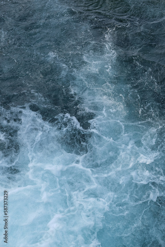Background ocean, bright blue color of sea splashing wave. Aerial view to ocean waves. Blue water background. Turbulent ocean composition. © Berg