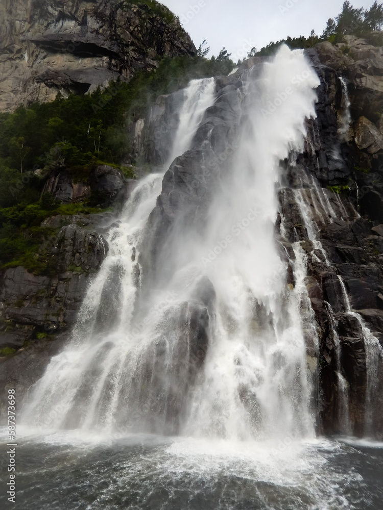 waterfall by a norwegin fjord waterfall by a norwegin fjord