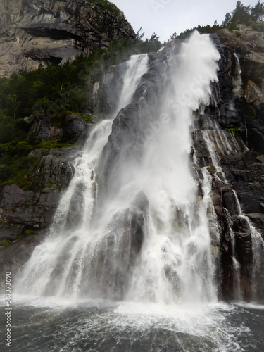 waterfall by a norwegin fjord