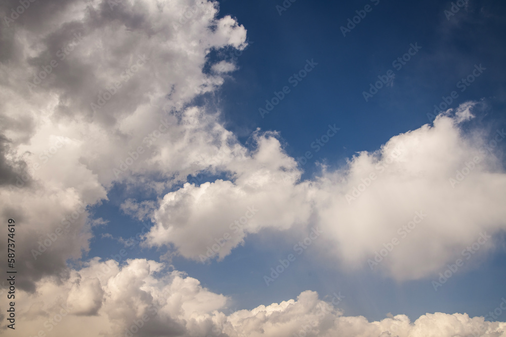 Obraz premium Beautiful huge fluffy clouds on the blue sky. Sky clouds background.