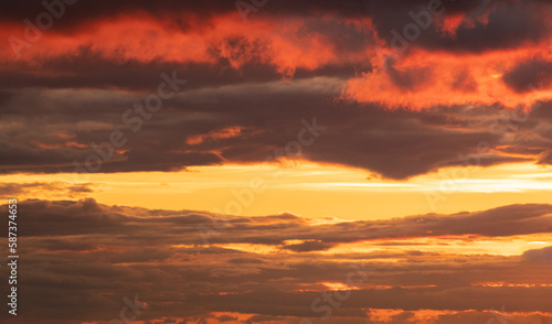 Beautiful bright orange sunset sky with dramatic clouds. Sunset sky with clouds background.
