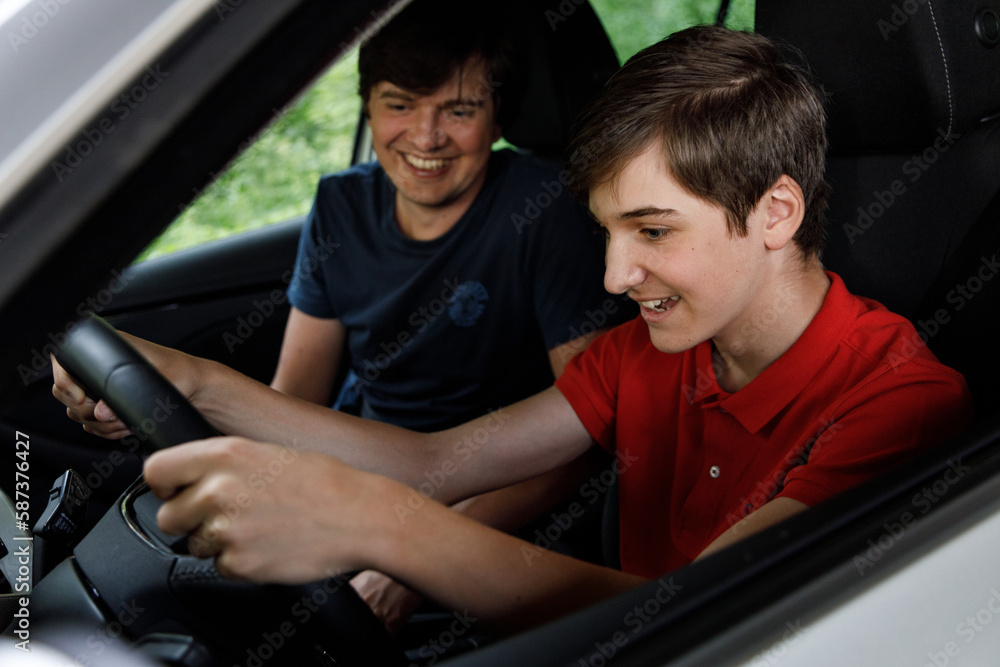 Teenage boy with a father learns driving Teenage boy with a father learns driving