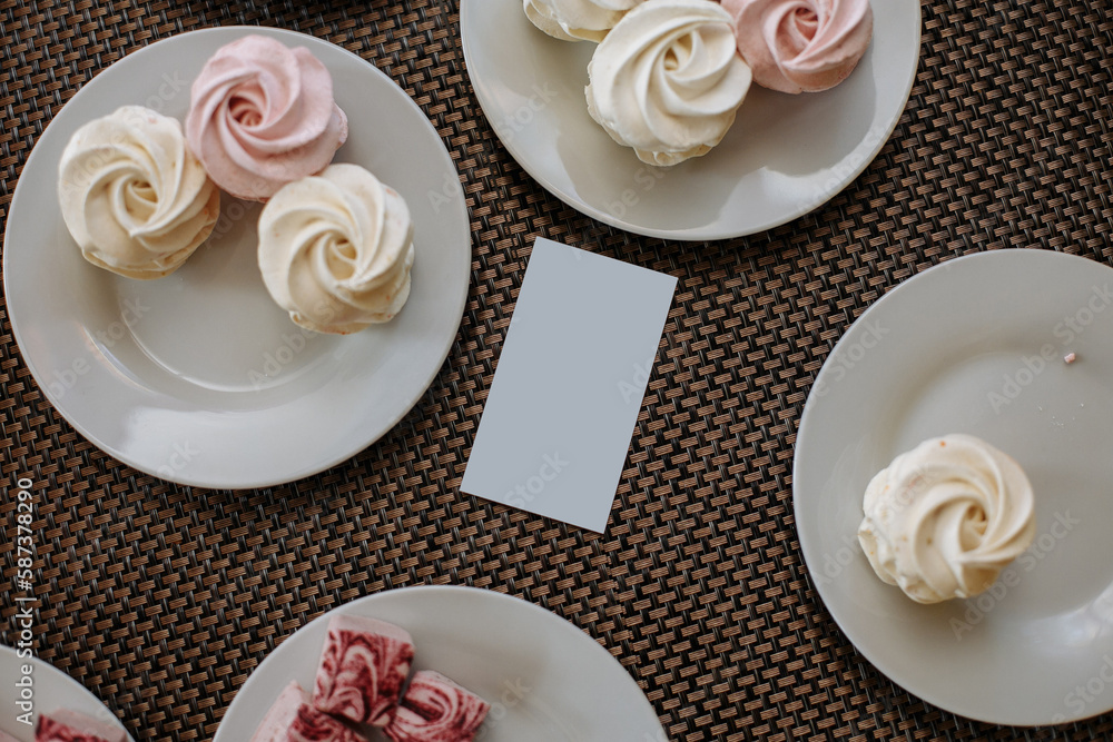 White and pink marshmallows on white plates
