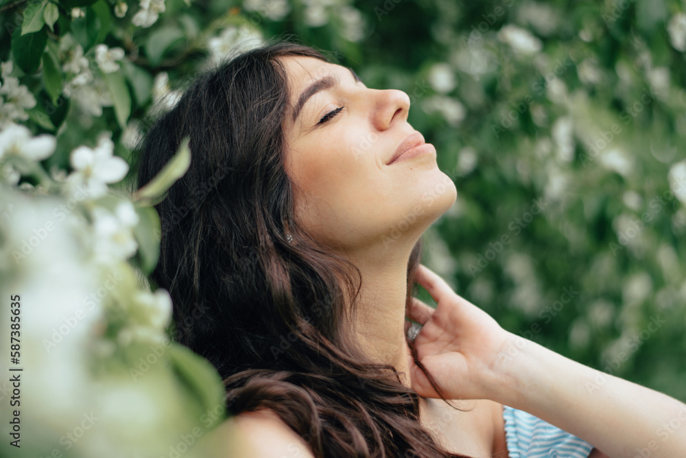 Portrait of a beautiful young woman in blooming apple trees.Spring,beauty,women's health concept. Portrait of a beautiful young woman in blooming apple trees.Spring,beauty,women's health concept.