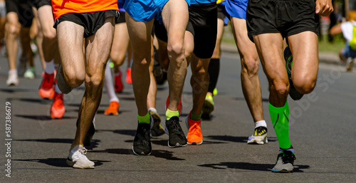 close-up legs runners running sport marathon, male jogging race in asphalt road, athletics competition