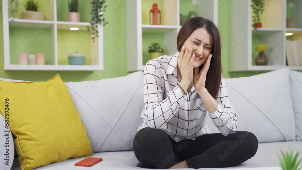 Troubled young woman crying at home, feeling unwell, unhappy and overwhelmed. Troubled young woman crying at home, feeling unwell, unhappy and overwhelmed.