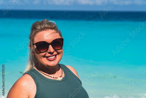 Blonde woman wearing sunglasses at the beach. Taken in Zanzibar