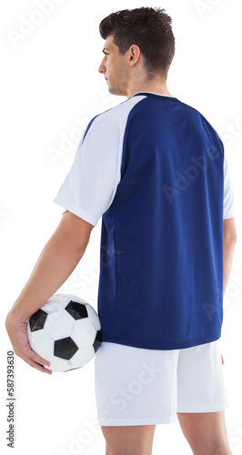 Rear view of sportsman holding football