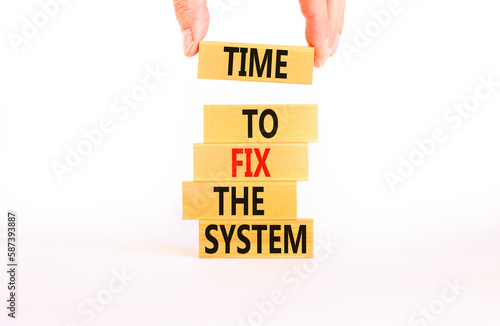 Time to fix the system symbol. Concept words Time to fix the system on wooden block. Beautiful white table white background. Businessman hand. Business and time to fix the system concept. Copy space.