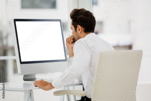Rear view of businessman looking at computer monitor