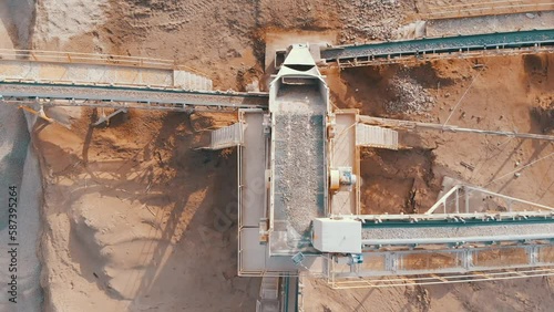 Stones crushing and gravel production on mining quarry. Stone jaw crusher plant. Screening in open-pit mining. Stone crushing plant.