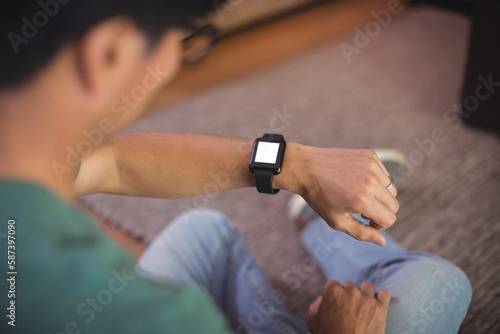 Man using smart watch in living room