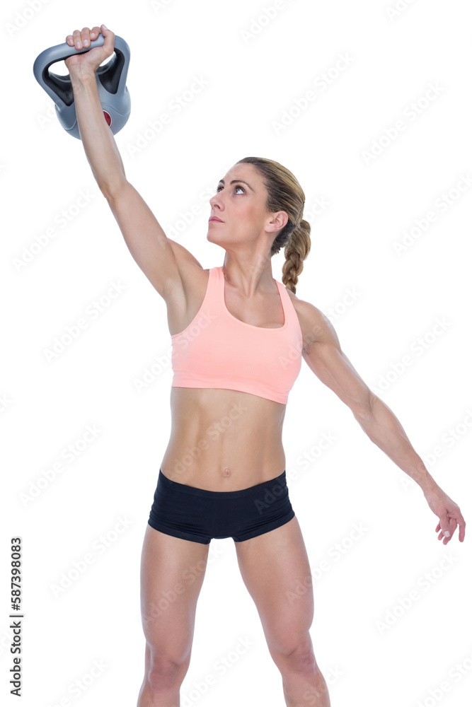 Female crossfitter lifting up kettlebell Female crossfitter lifting up kettlebell