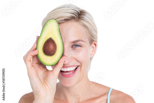 Pretty woman covering her eye with an avocado 