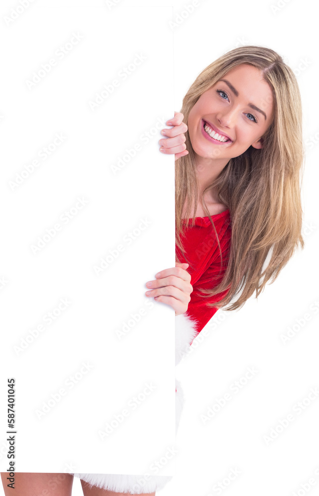 Pretty santa girl smiling at camera behind poster Pretty santa girl smiling at camera behind poster