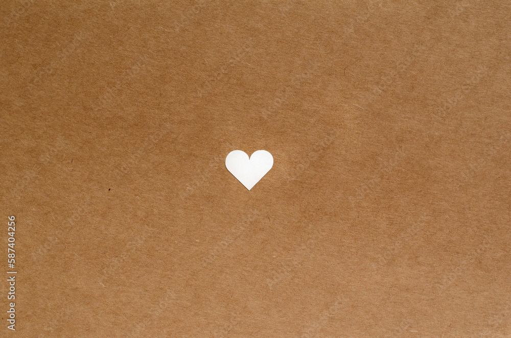 Obraz premium small cute heart on brown craft paper background