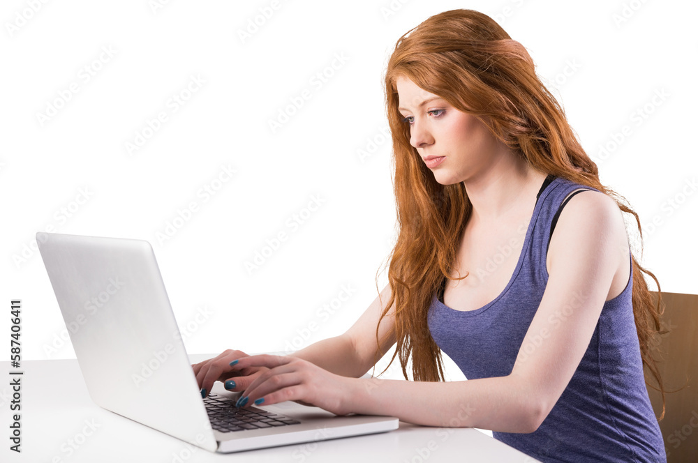 Pretty redhead working on laptop