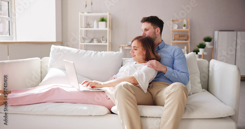 Family Couple Using Laptop And Tablet