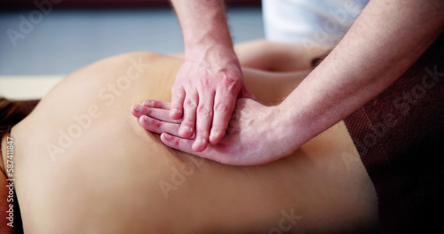 Woman Receiving Back Massage From Therapist