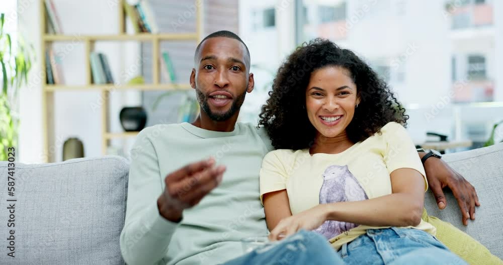 Laughing, popcorn and couple watching tv in home, bonding and enjoying comedy movie. Interracial, television and funny black man and woman eating food, streaming or comic video, relax or talk on sofa Laughing, popcorn and couple watching tv in home, bonding and enjoying comedy movie. Interracial, television and funny black man and woman eating food, streaming or comic video, relax or talk on sofa