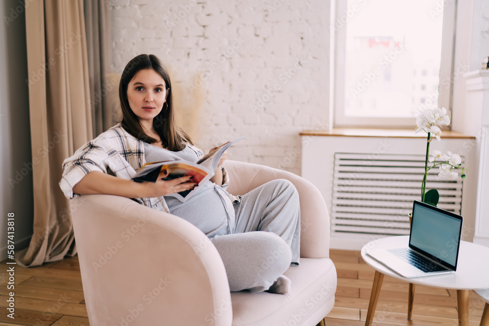 Smiling in the club woman reading magazine in living room Smiling in the club woman reading magazine in living room