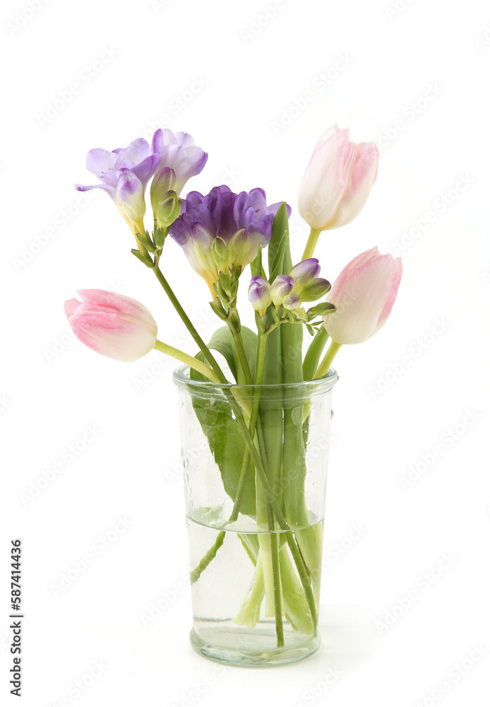 Flowers Tulip and Freesia in vase isolated on white background. Bouquet of purple pink spring flowers. Flowers Tulip and Freesia in vase isolated on white background. Bouquet of purple pink spring flowers.