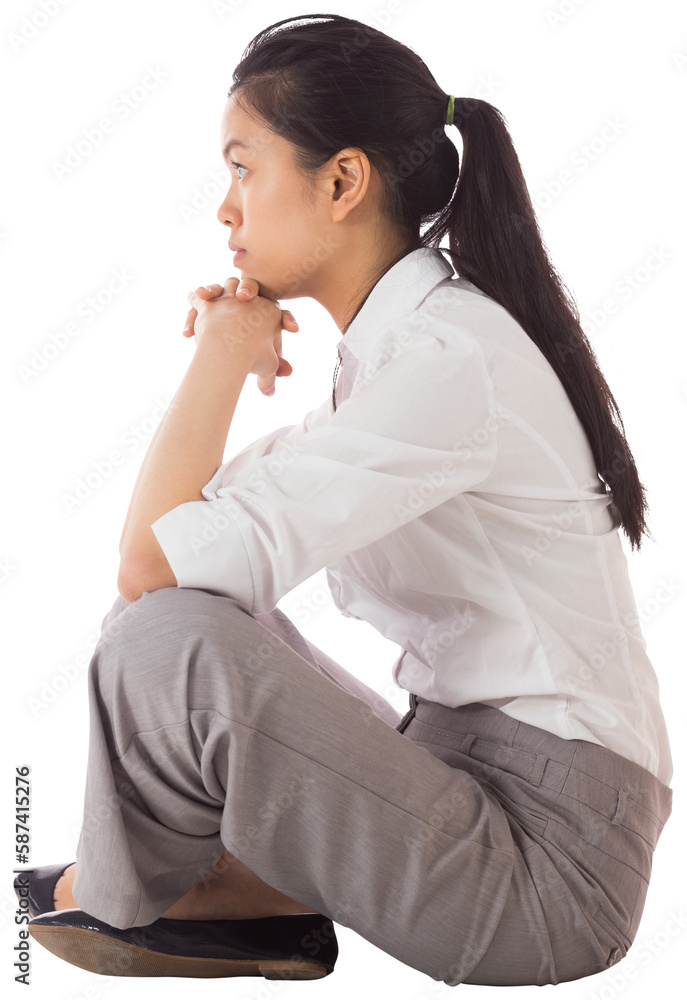 Businesswoman sitting cross legged with hands together